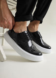 Men's Empoli Noir Elegance by Apollo Moda, patent black dress shoe with white sole, worn view