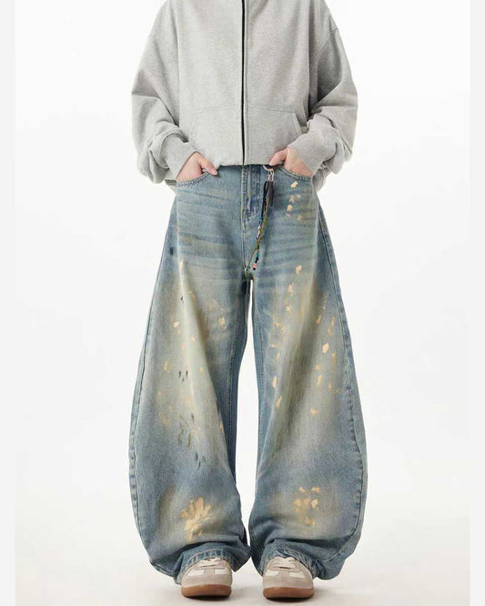 Jeans in denim a gamba larga curva e a barile con spruzzi dorati dipinti a mano